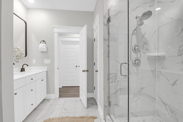 779 Forrest Dr, Charleston, SC 29492 - bathroom featuring a marble finish shower, vanity, marble look tiles, and baseboards