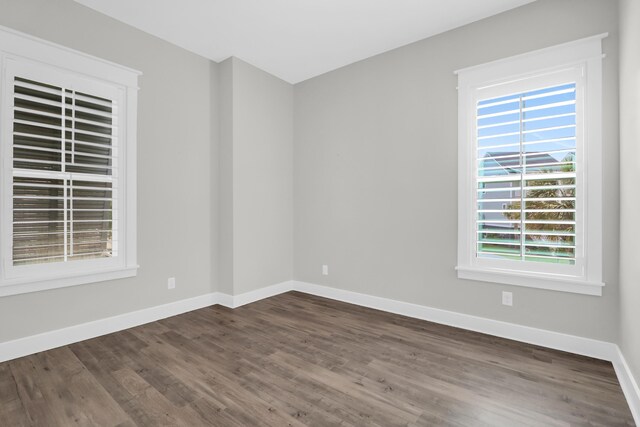 779 Forrest Dr, Charleston, SC 29492 - empty room with dark wood-type flooring, healthy amount of natural light, and baseboards
