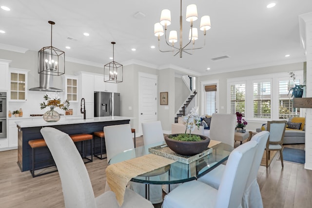 779 Forrest Dr, Charleston, SC 29492 - dining space featuring a chandelier, stairs, light wood finished floors, ornamental molding, and recessed lighting