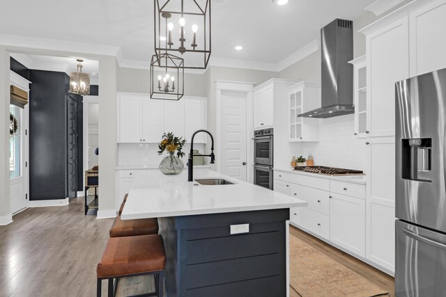 779 Forrest Dr, Charleston, SC 29492 - kitchen with appliances with stainless steel finishes, a chandelier, wall chimney range hood, crown molding, and backsplash