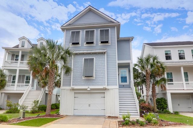 779 Forrest Dr, Charleston, SC 29492 - raised beach house featuring an attached garage, a standing seam roof, metal roof, concrete driveway, and stairway