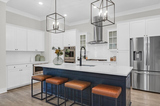 779 Forrest Dr, Charleston, SC 29492 - kitchen with stainless steel appliances, a chandelier, wall chimney range hood, a sink, and tasteful backsplash
