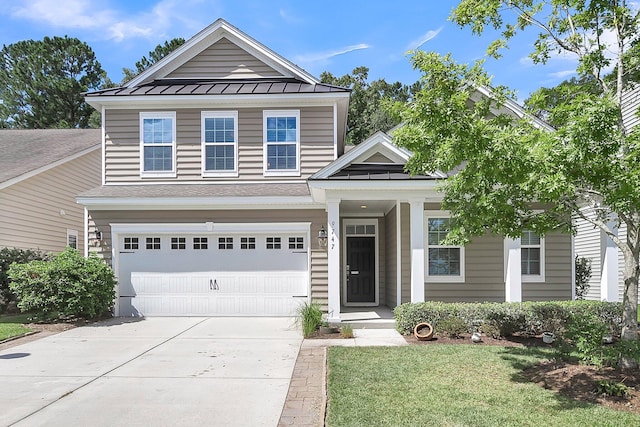 view of front of property with a garage and a front yard