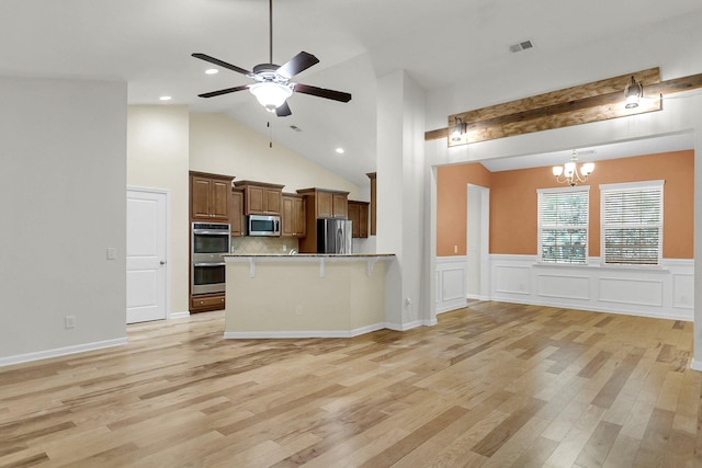 kitchen with stainless steel appliances, open floor plan, visible vents, and a peninsula