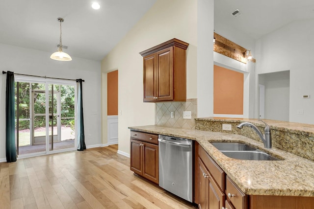 kitchen with dishwasher, lofted ceiling, light stone counters, backsplash, and a sink