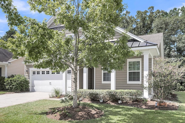 view of front of home featuring a garage and a front lawn