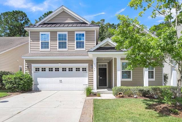 traditional home with metal roof, a shingled roof, concrete driveway, a front lawn, and a standing seam roof