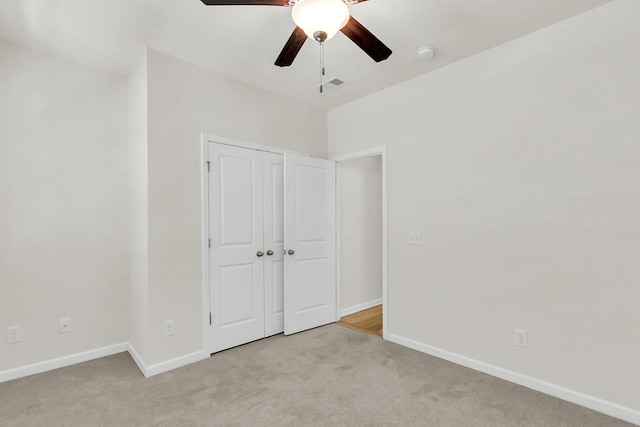 unfurnished bedroom with light carpet, baseboards, visible vents, and a closet