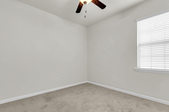 unfurnished room with light carpet, ceiling fan, and baseboards