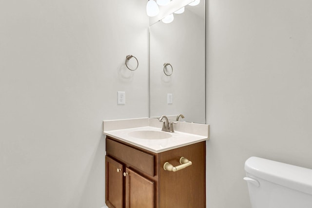 bathroom featuring toilet and vanity