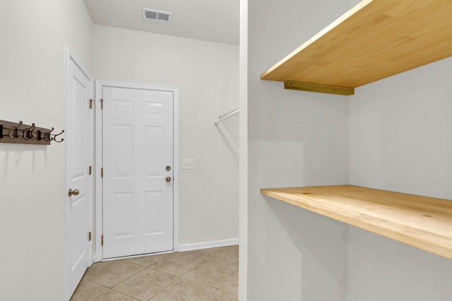 spacious closet featuring light tile patterned flooring and visible vents