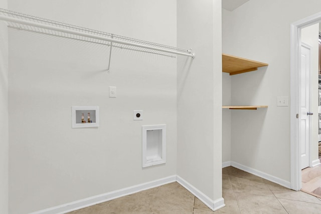 laundry area featuring light tile patterned floors, hookup for an electric dryer, laundry area, washer hookup, and baseboards