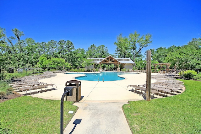 community pool featuring a yard, a patio area, fence, and a pergola