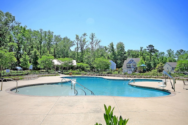 pool featuring a patio and fence