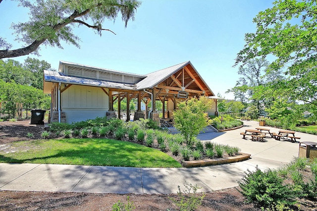 exterior space featuring board and batten siding and a patio area