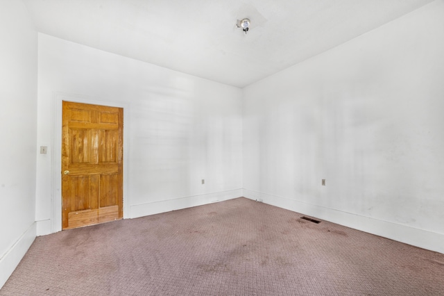 unfurnished room with visible vents and carpet floors