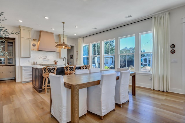 dining area featuring recessed lighting, light wood-style floors, visible vents, and a healthy amount of sunlight