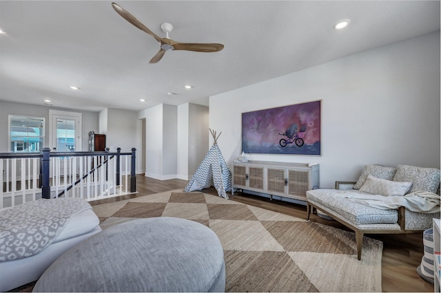 living room featuring a ceiling fan, recessed lighting, wood finished floors, and baseboards