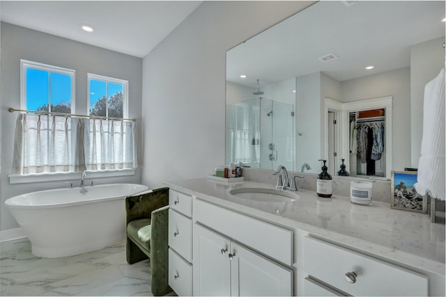 full bath with vanity, a soaking tub, recessed lighting, a stall shower, and marble finish floor