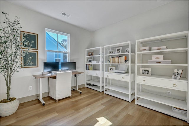 office space with visible vents, baseboards, and wood finished floors