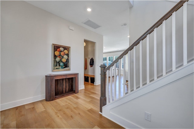 staircase featuring recessed lighting, wood finished floors, visible vents, and baseboards