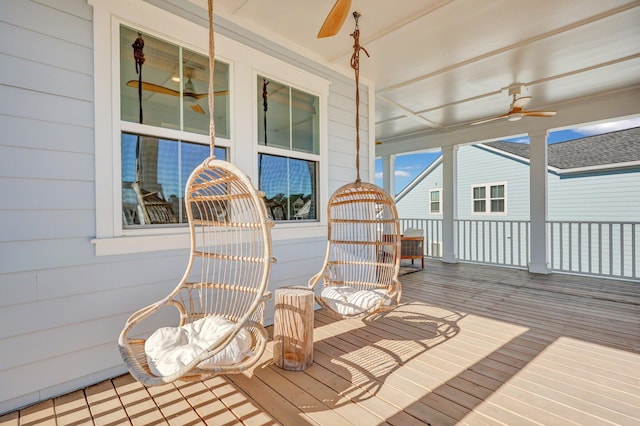 wooden deck with a ceiling fan