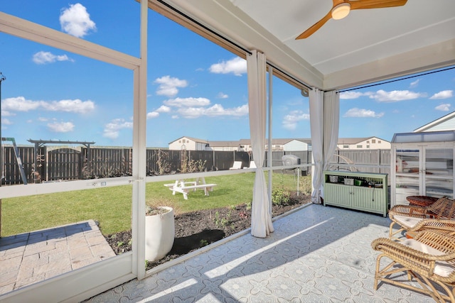 sunroom featuring a ceiling fan