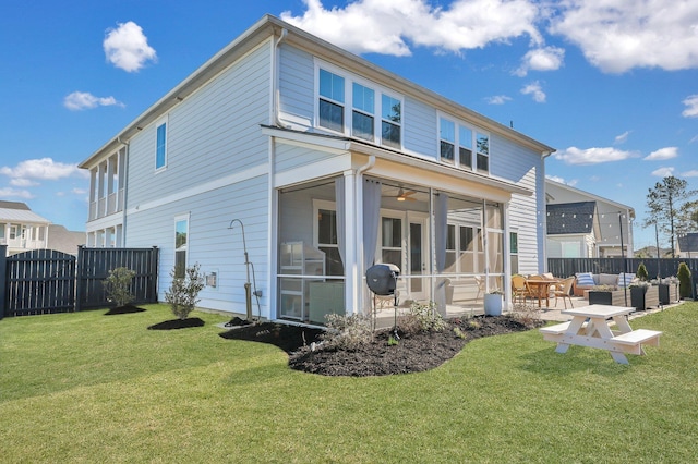 back of house featuring a patio, fence, a yard, a sunroom, and an outdoor hangout area