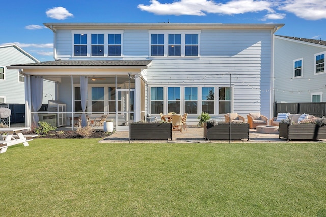 rear view of property with fence, an outdoor living space, a sunroom, a patio area, and a lawn