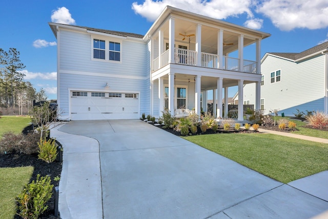 view of front of property with driveway, a ceiling fan, a front yard, a garage, and a balcony