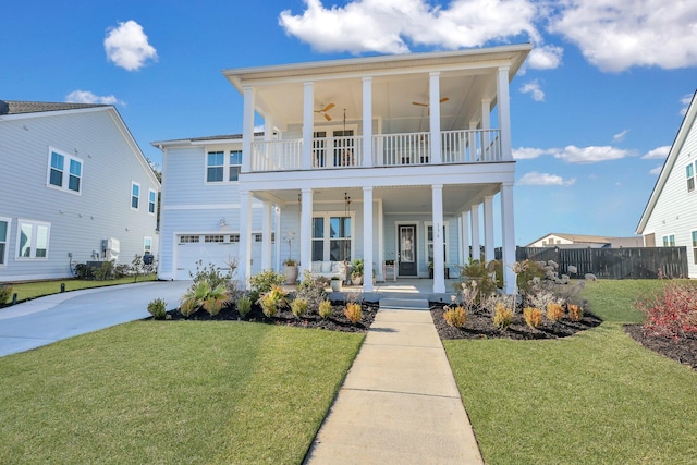 view of front of property with a front lawn, fence, covered porch, concrete driveway, and a balcony