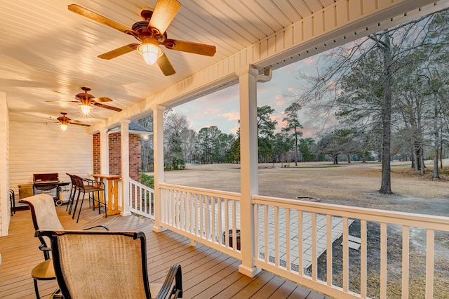 wooden deck with a ceiling fan