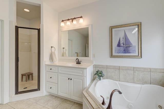 full bath with a stall shower, tile patterned flooring, vanity, and a whirlpool tub