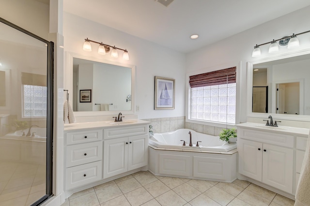 bathroom with a bath, tile patterned flooring, and a sink