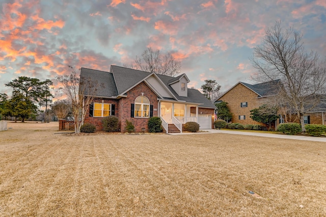 view of front of property with crawl space, a garage, a front yard, and brick siding