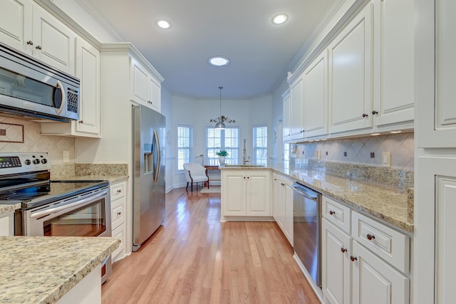 kitchen featuring beverage cooler, white cabinets, light wood-style flooring, appliances with stainless steel finishes, and a sink