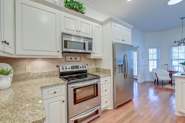 kitchen featuring stainless steel appliances, white cabinetry, backsplash, light wood finished floors, and crown molding