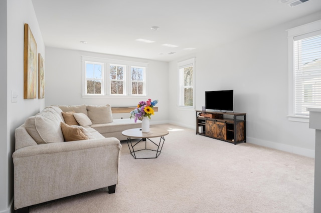 carpeted living room featuring visible vents and baseboards