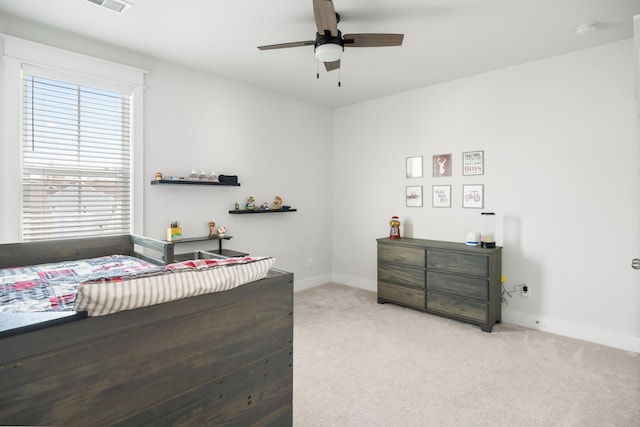 carpeted bedroom featuring a ceiling fan and baseboards