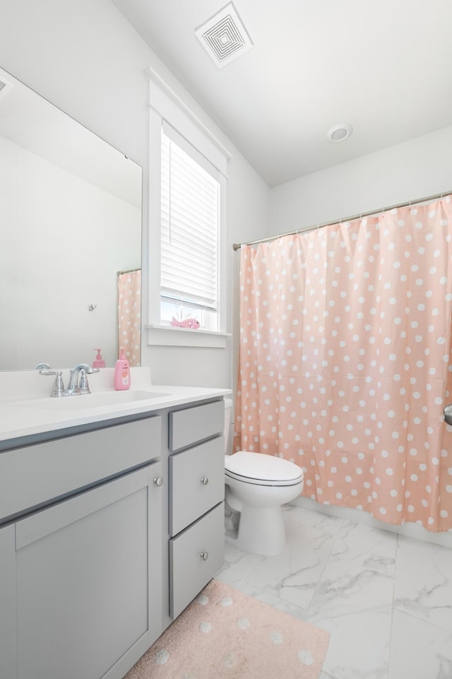 full bath featuring visible vents, toilet, marble finish floor, a shower with shower curtain, and vanity