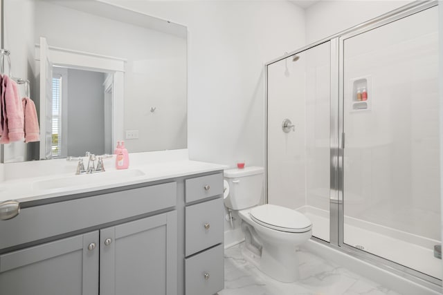 full bathroom featuring vanity, toilet, a stall shower, and marble finish floor