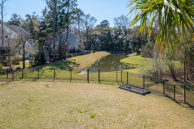 view of yard featuring a water view and fence