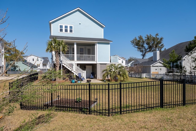 view of front of property featuring a residential view, a front lawn, a fenced backyard, and stairs