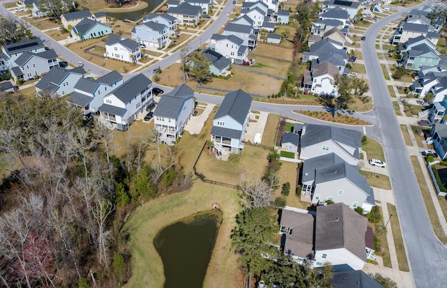 birds eye view of property with a residential view and a water view