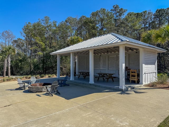 exterior space with a gazebo, a patio area, and an outdoor fire pit