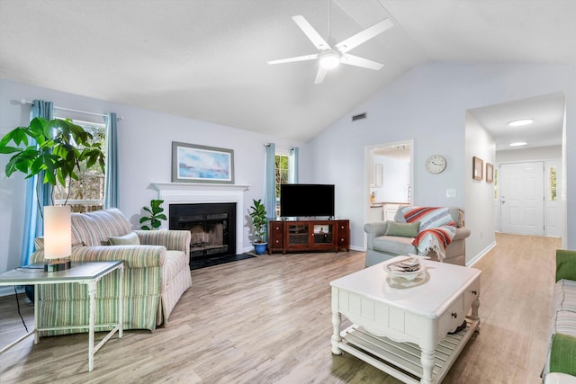 1227 Ocean View Rd, Charleston, SC 29412 - living area featuring a fireplace with flush hearth, light wood finished floors, ceiling fan, and high vaulted ceiling