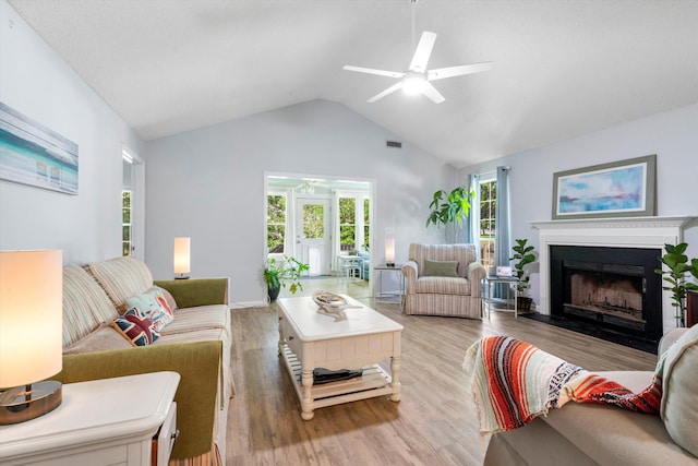 1227 Ocean View Rd, Charleston, SC 29412 - living area featuring a ceiling fan, wood finished floors, a fireplace with flush hearth, and high vaulted ceiling