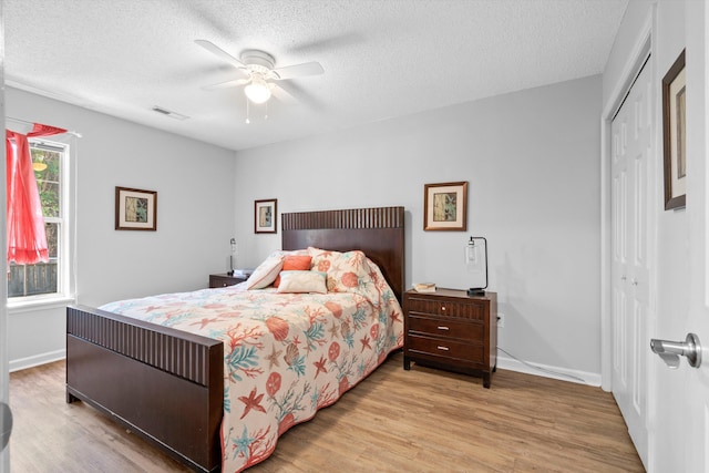 1227 Ocean View Rd, Charleston, SC 29412 - bedroom featuring wood finished floors, a closet, a textured ceiling, ceiling fan, and baseboards
