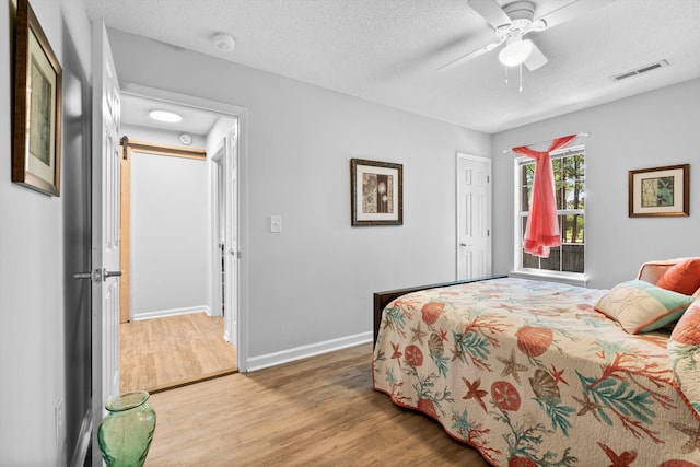 1227 Ocean View Rd, Charleston, SC 29412 - bedroom featuring wood finished floors, a textured ceiling, baseboards, and a ceiling fan