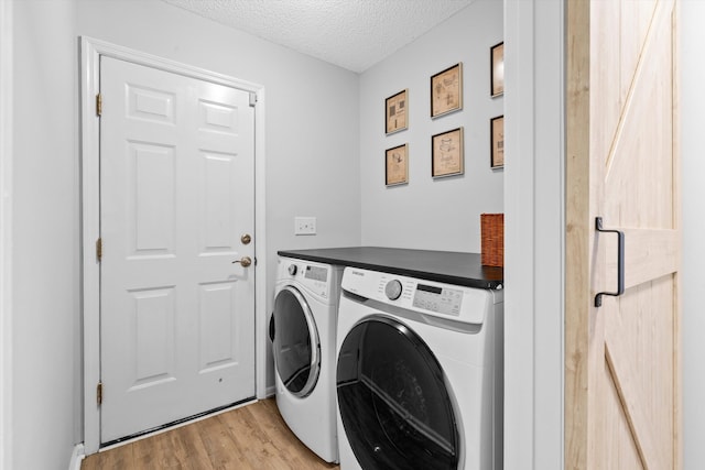 1227 Ocean View Rd, Charleston, SC 29412 - laundry room with washing machine and dryer, light wood-style floors, and a textured ceiling